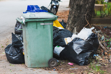 Plastic bins filled with trash and debris in public places