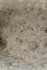 Top view of toilet with foam and bubbles with rainbow colors reflections and bokeh lights. Photo taken October 31st, 2024, Zurich, Switzerland.