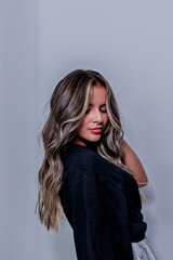 Fototapeta premium Young Hispanic, Latina, Peruvian woman in front of the camera playing with her hair, with different expressions 