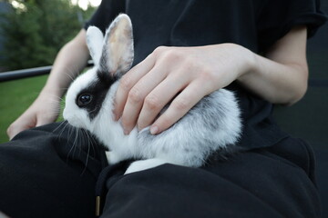 Woman playing with a small rabbit