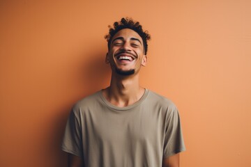 Fototapeta premium Portrait of a joyful man in his 20s donning a trendy cropped top isolated in blank studio backdrop