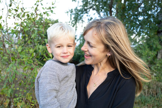 Portrait of a mother holding her son in her arms, smiling, Beckwith Township at Carleton Place in the Ottawa Valley; Ontario, Canada