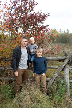 Portrait of a father posing with his two sons in a fall, rural setting, Beckwith Township at Carleton Place in the Ottawa Valley; Ontario, Canada