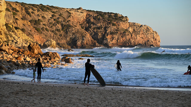 Surfers ready to catch a wave at the surfing destination Praia do Zavial, at Sagres in the Algarve region of Portugal; Raposeira, Faro, Portugal