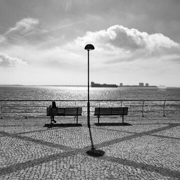 Seating along the waterfront with a view of the busy port of Setubal, Portugal