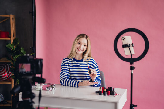 Photo of lovely girl professional blogger makeup artist showing cosmetics products review live stream video vlog channel