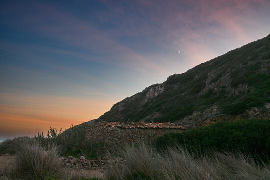 Natural rugged landscape at Praia das Furnas along the coastline of Portugal at sunset; Budens, Faro, Portugal
