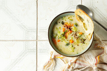 bowl of broccoli cheese soup on  a table