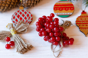 DIY decorations for Christmas. Xmas card. Christmas composition with Ukrainian doll-motanka, wooden balls, snowball tree, cones and fir branches. New Year eco-conscious handmade toys. Happy holidays.