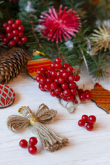 Eco Christmas. Xmas card. Christmas composition with Ukrainian doll-motanka, wooden balls, snowball tree, cones and fir branches. New Year eco-conscious handmade toys. Happy holidays.