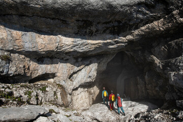 Cavers approach the entrance of an ice cave in the European Alps of Austria