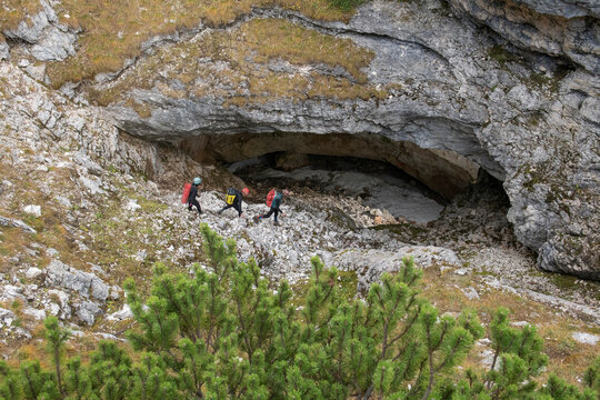 Scientists from University of Innsbruck hiking on mountainside to ice caves, Tyrol Region of Austria