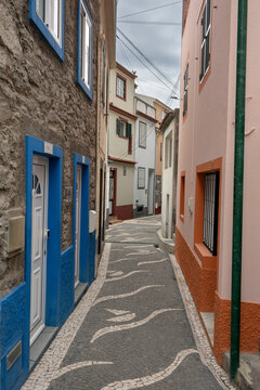 Narrow walkway with nautical themed designs in the stonework between housing in Paul do Mar on the island of Madeira, Portugal; Paul do Mar, Madeira, Portugal