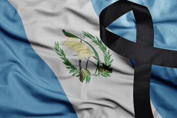 waving national flag of guatemala with black mourning ribbon . tragedy concept