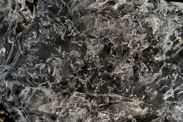Ice showing a network of cracks creating an abstract design
