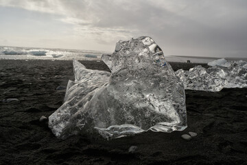 Transparent iceberg melting on black sand beach in iceland © Eclipsnet