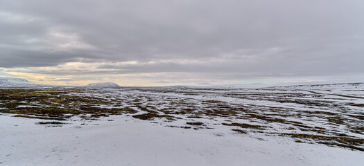 Desolate winter landscape covered with snow and rocks