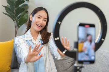 Influencer live internet, happy vlog asian young woman blogger using smart phone talking on video...