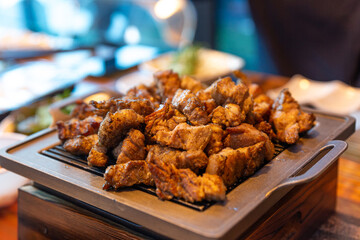 A Delicious Korean BBQ Platter with Grilled Meat and Vegetables Served on a Hot Plate, Surrounded by Side Dishes