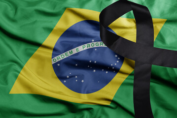 waving national flag of brazil with black mourning ribbon . tragedy concept