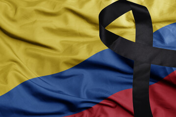 waving national flag of colombia with black mourning ribbon . tragedy concept