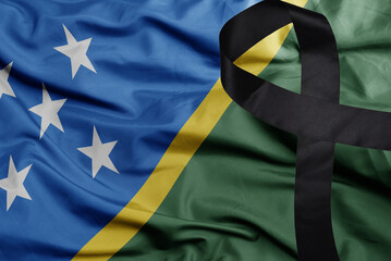 waving national flag of Solomon Islands with black mourning ribbon . tragedy concept