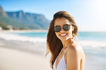 Young woman, portrait and beach with smile, holiday and bikini on spring break with travel. Vacation, sunglasses and Mediterranean sea with trip, outdoor and ocean with female person from Italy