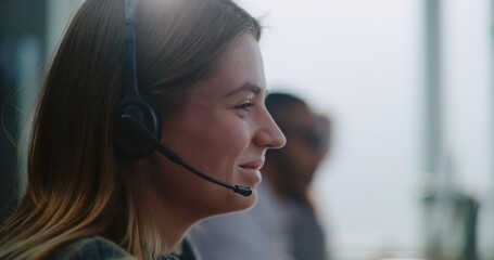 Call center office: Close up of young Caucasian technical customer support specialist in headset...