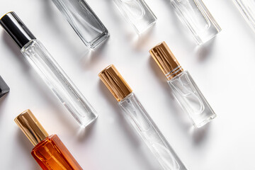 Different perfume bottles on white background. Perfume of different volume. Pattern