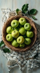 Fresh green apples arranged in a woven basket on a checkered cloth at a kitchen countertop