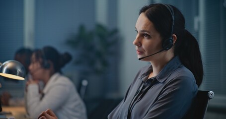 Call center office of mental health helpline: Close up of Caucasian female crisis hotline worker...
