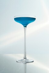 Blue Cocktail in a Tall Stem Glass with Flower Garnish