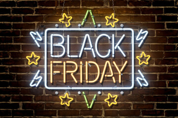 Illuminated Black Friday sign in neon style with star decorations on brick wall for holiday sale advertisements