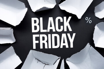 Black Friday sale text with scattered torn paper pieces for edgy and dynamic holiday shopping promotions