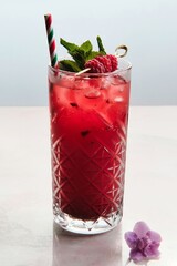 Vibrant Red Cocktail Garnished with Mint and Raspberries