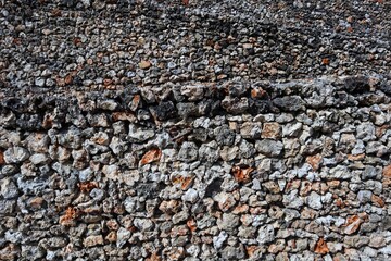 Close-Up of a textured stone wall with varying patterns and colors.