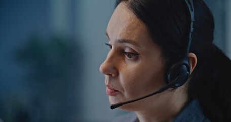 Modern call center office of mental health line: Close up of Caucasian hotline specialist in headset talking to person, consulting online, providing psychological assistance and emotional support.