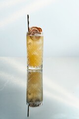 Icy Yellow Cocktail Garnished with Orange Chips