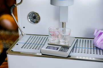 Measuring coffee with a scale. Measuring coffee affects the taste and aroma of the coffee beans.