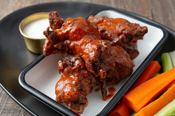 A closeup view of an entree of Buffalo wings.