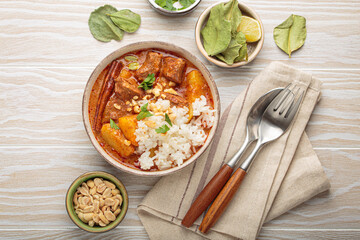 Aromatic massaman curry, a staple of thai cuisine, with tender beef, potatoes, and fluffy rice, garnished with peanuts and fresh herbs, a vibrant and flavorful dish of Thailand
