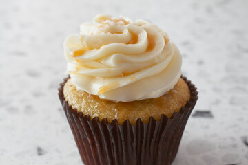 A closeup view of a salted caramel cupcake.