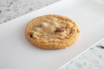 A view of a chocolate chip cookie on a plate.
