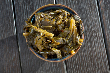A top down view of a small bowl of collard greens.