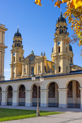 The Theatine church in Munich shot from the Hofgarten area in autumn.