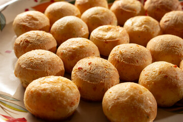 A view of some pao de queijo on a plate.