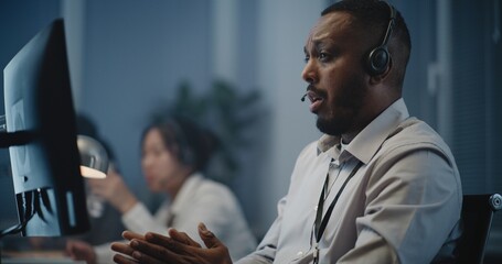 Modern call center office of mental health line: Close up portrait of African American hotline...