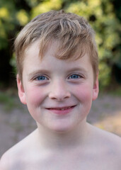 Smiling blond boy with freckles.