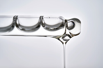 Dropper pipette with delicious serum with drop close-up.