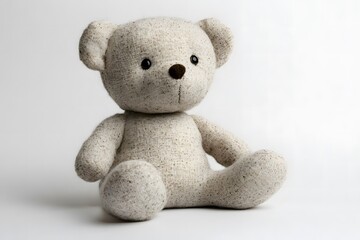 Soft fabric teddy bear made from organic cotton, isolated on a white background